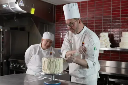 Chef Jurgen David demonstrating cake decoration.