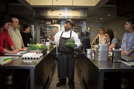 A chef with greens during the zero waste event.