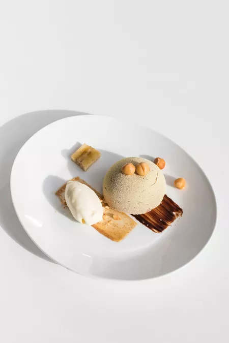 A plated dessert of chocolate and hazelnuts, prepared by ICE pastry students