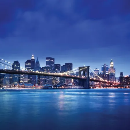 a photo of the Brooklyn bridge with Manhattan NYC- home to ICE Tourism, Travel & Hospitality Management program- behind it at dusk