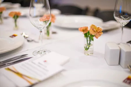 A table set with farm flowers and an ICE menu