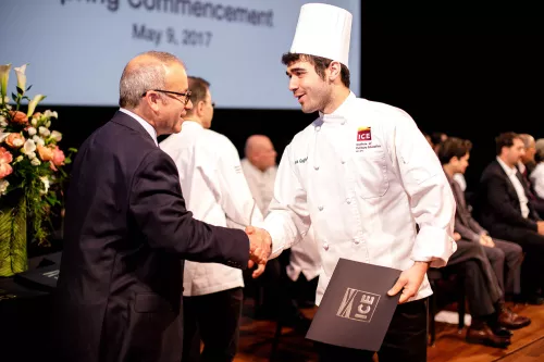 A student shakes hands at the Institute of Culinary Education 2017 commencement ceremony