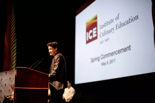 ICE graduate Jonathan Defren speaks to the graduating ICE students at their graduation ceremony from the Institute of Culinary Education