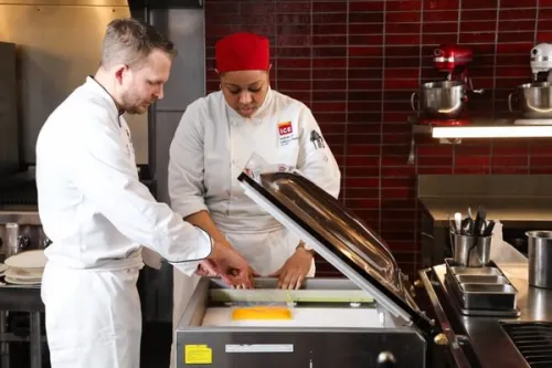 a chef and an Advanced Cuisine & Technique student use a sous vide machine