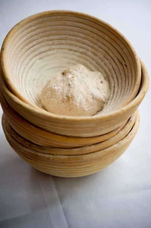 Dough rests in a traditional basket made for shaping breads
