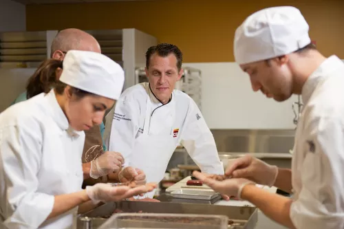 Michael Laiskonis oversees ICE students sorting cacao beans in the chocolate lab at the Institute of Culinary Education