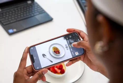 A student takes a photo of a creme brûlée on an iPhone 