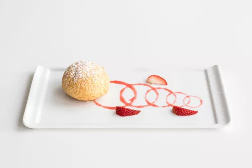 Plated dessert of crunchy choux pastry and strawberries prepared by ICE pastry students