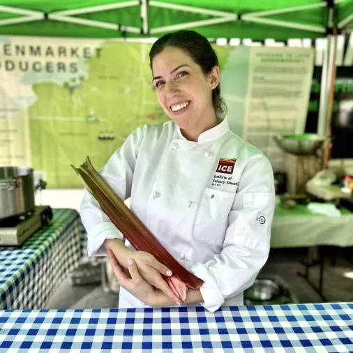 ICE Chef Ann Ziata holds a rhubarb at the Union Square Greenmarket