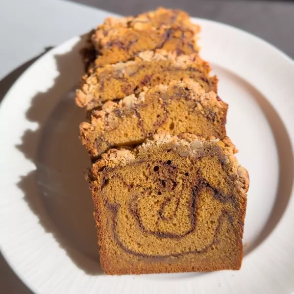 Slices of Pumpkin Cinnamon Swirl Bread on a white plate