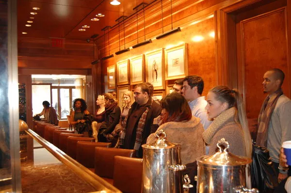 Tourism, Travel & Hospitality Management students stand at a bar during a field trip to learn about food & beverage management 