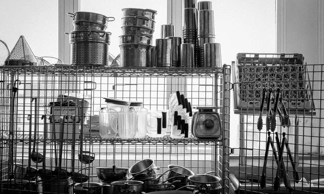 Culinary tools rest on racks inside a kitchen at the Institute of Culinary Education
