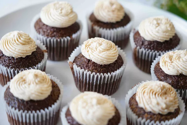 Plate of chocolate cupcakes with vanilla icing