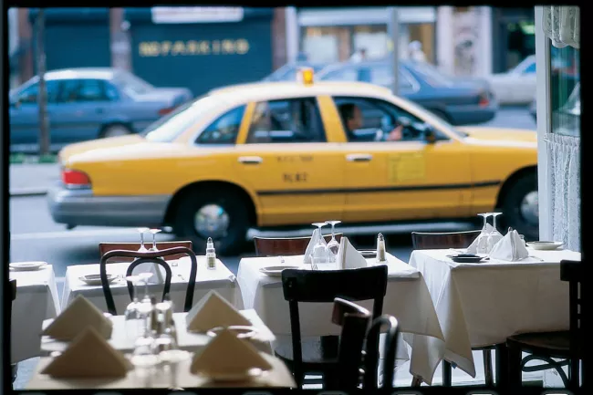 View of a NYC cab outside a restaurant window