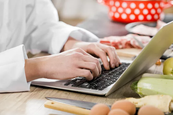 Culinary student typing on laptop