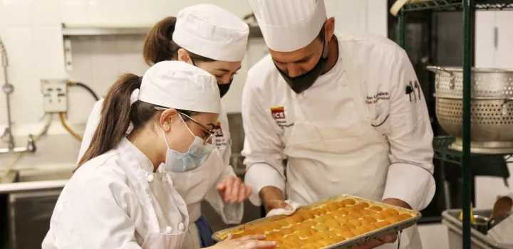 Chef Alon working with pastry students at ICE