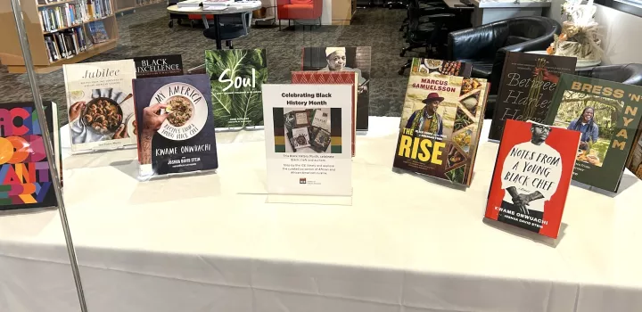Multiple cookbooks written by Black authors are displayed in ICE's New York campus library