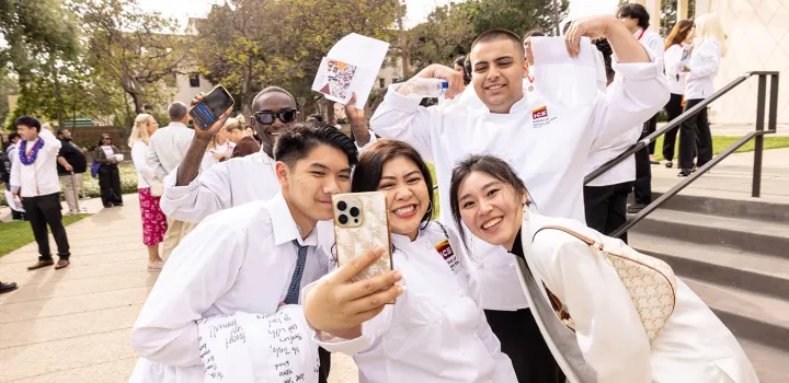 Culinary school graduates smile at ICE's commencement ceremony