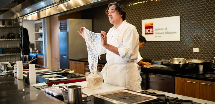 Chef Paul Liebrandt displays caul fat during an Elite Chef Series demo at ICE.
