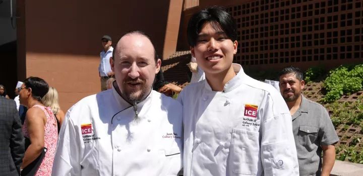 ICE Chef Jason Hawk and ICE graduate Steven Gao smile at ICE's commencement ceremony