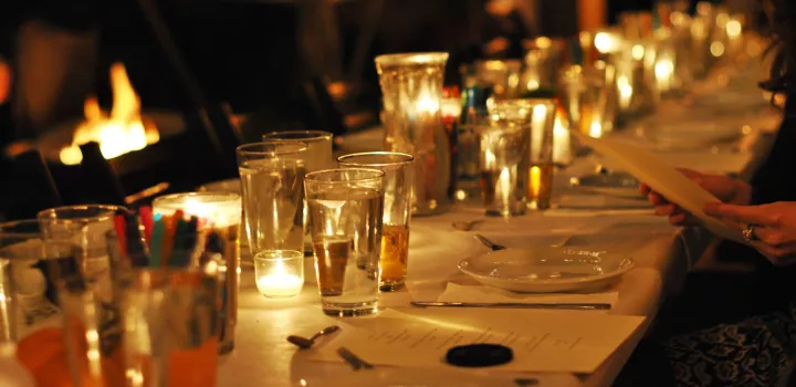 Dimly lit dining table with glasses