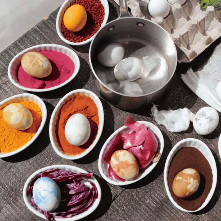 dyed eggs pictured with the natural dyeing ingredients
