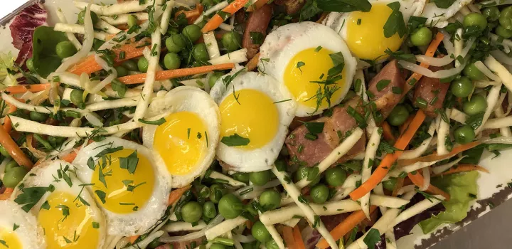 Eggs atop a salad in a Culinary Arts class