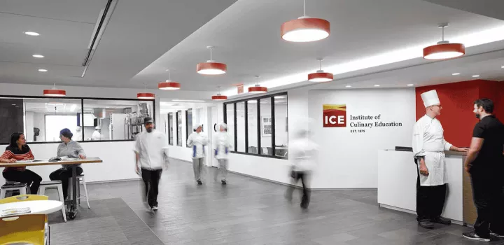 people walking in lobby of ICE New York campus