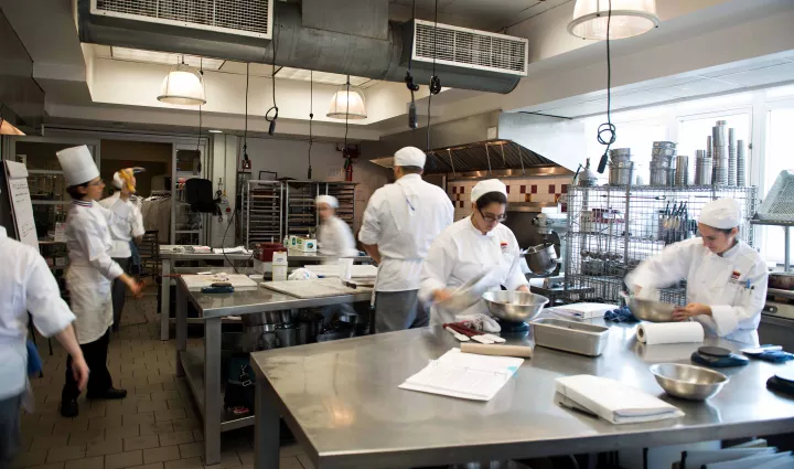 Students learn techniques in a pastry kitchen at the Institute of Culinary Education