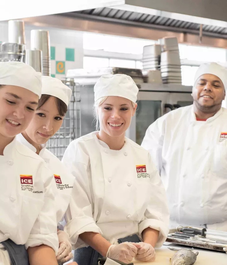 ICE students smiling in culinary school at the Institute of Culinary Education, named "the best culinary school" by The Daily Meal